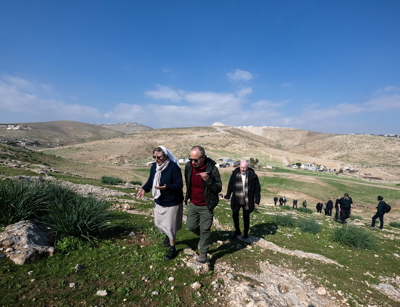 Bishops walking up a hillside